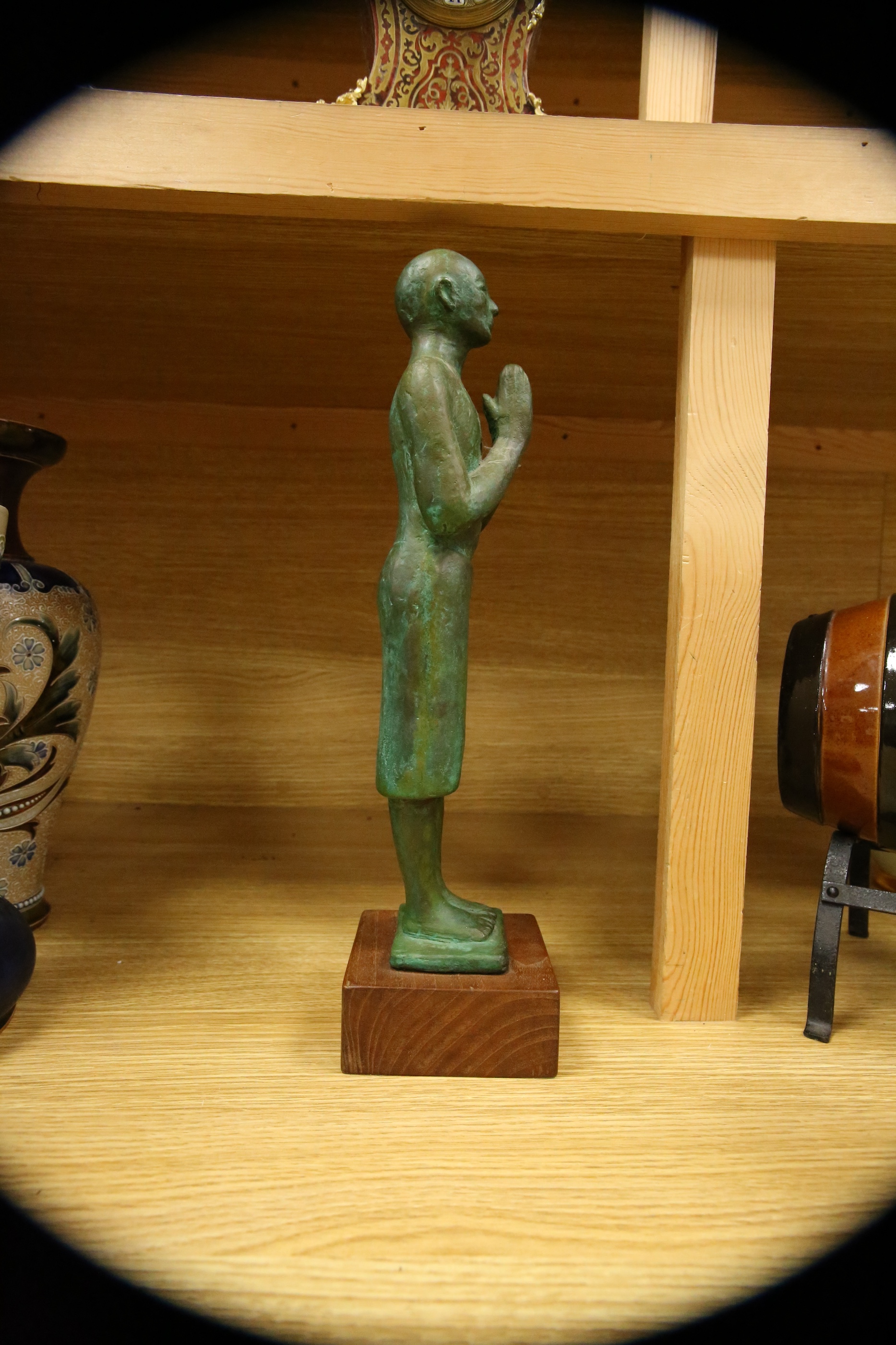 A figural bronze of an Oriental gentleman in prayer, height 42cm including stand. Condition - good